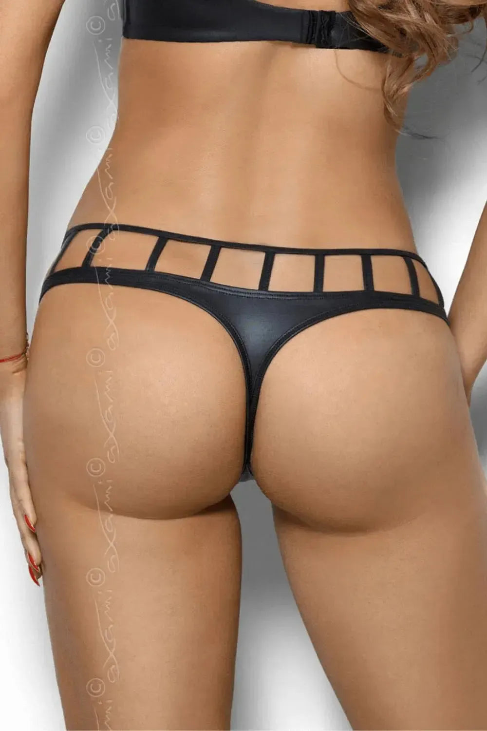 Axami Illusions Caged Thong: black matte latex with geometric stripes, seductively highlighting curves.