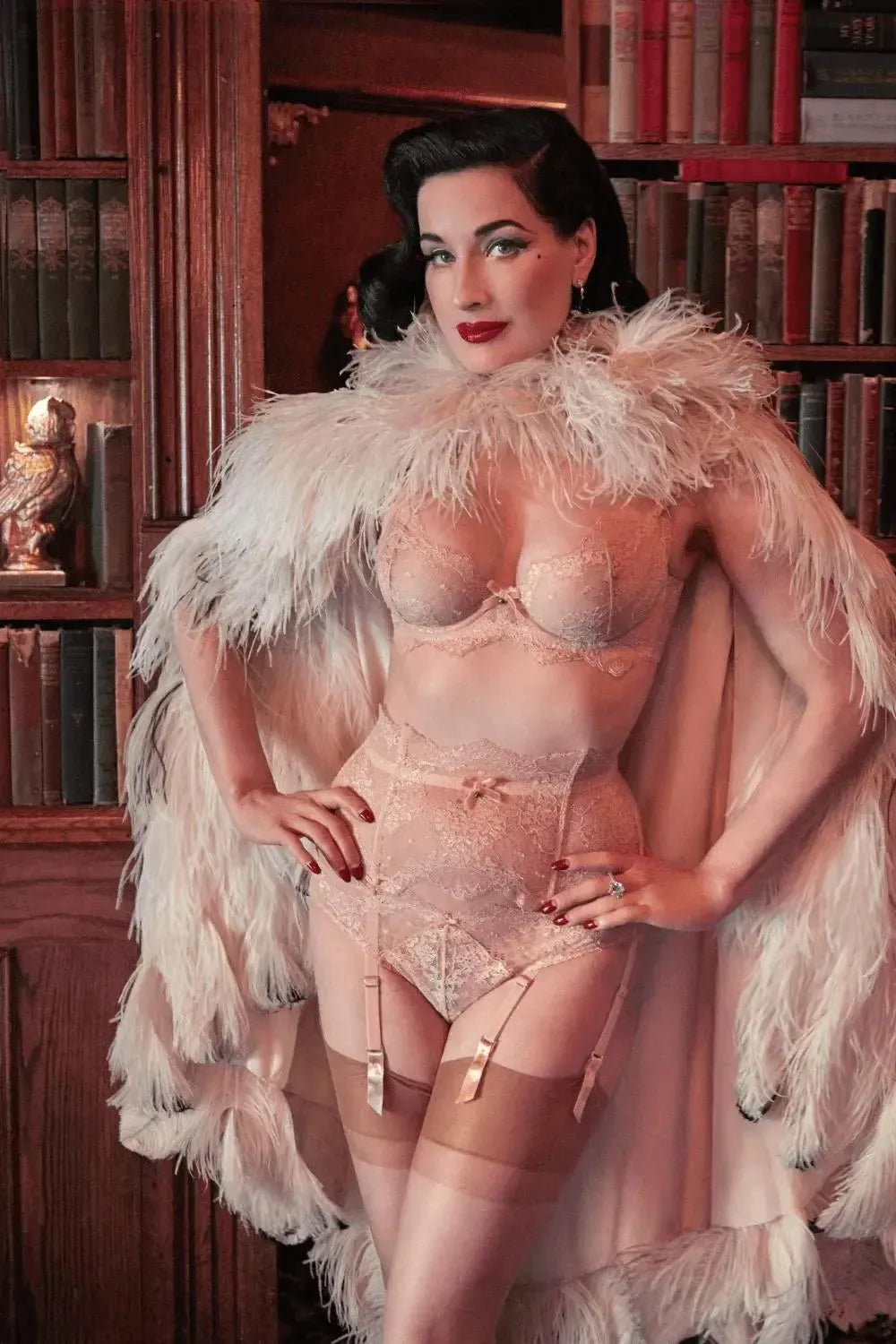 Dita Von Teese in Vintage Peach Lurex Lace bikini panty, bra, and garter, with a feather cape.