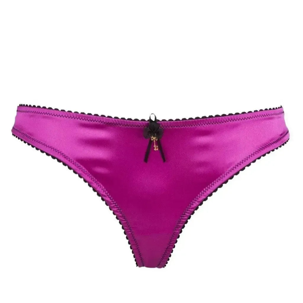 Seductively playful Raissa satin thong panty in vibrant pink with black lace trim and delicate bow.